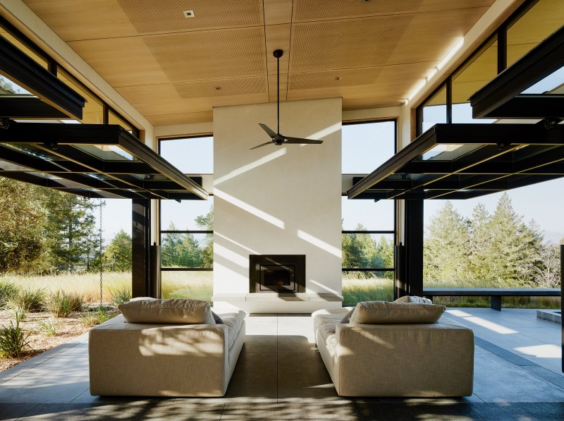A Northern California House that Blends in with Its Natural Surroundings california house A Northern California House that Blends in with Natural Surroundings glazed garage doors by renlita lift up to completely open the home to nature