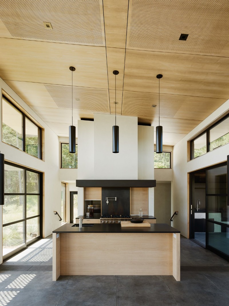 A Northern California House that Blends in with Its Natural Surroundings california house A Northern California House that Blends in with Natural Surroundings warm wood and dark surfaces contrast with white walls